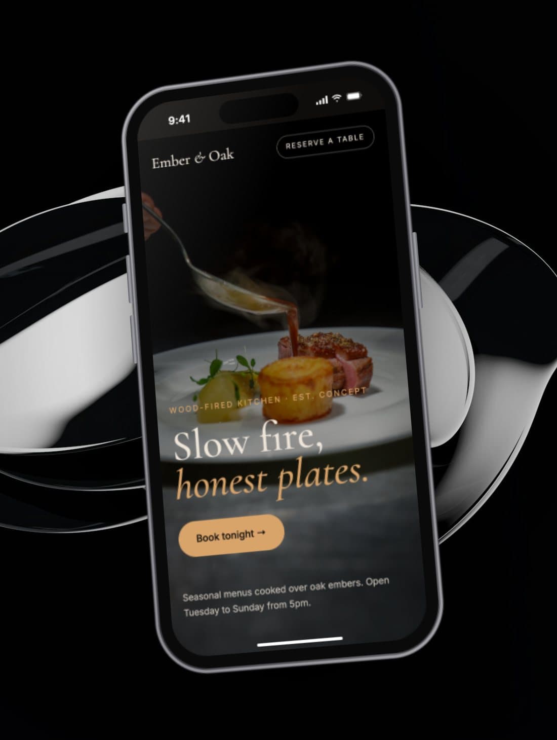 Concept restaurant website shown on a phone, in front of a chrome sculpture